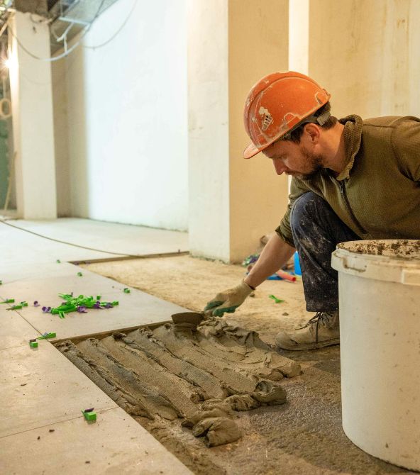 Professional tiler installing tiles